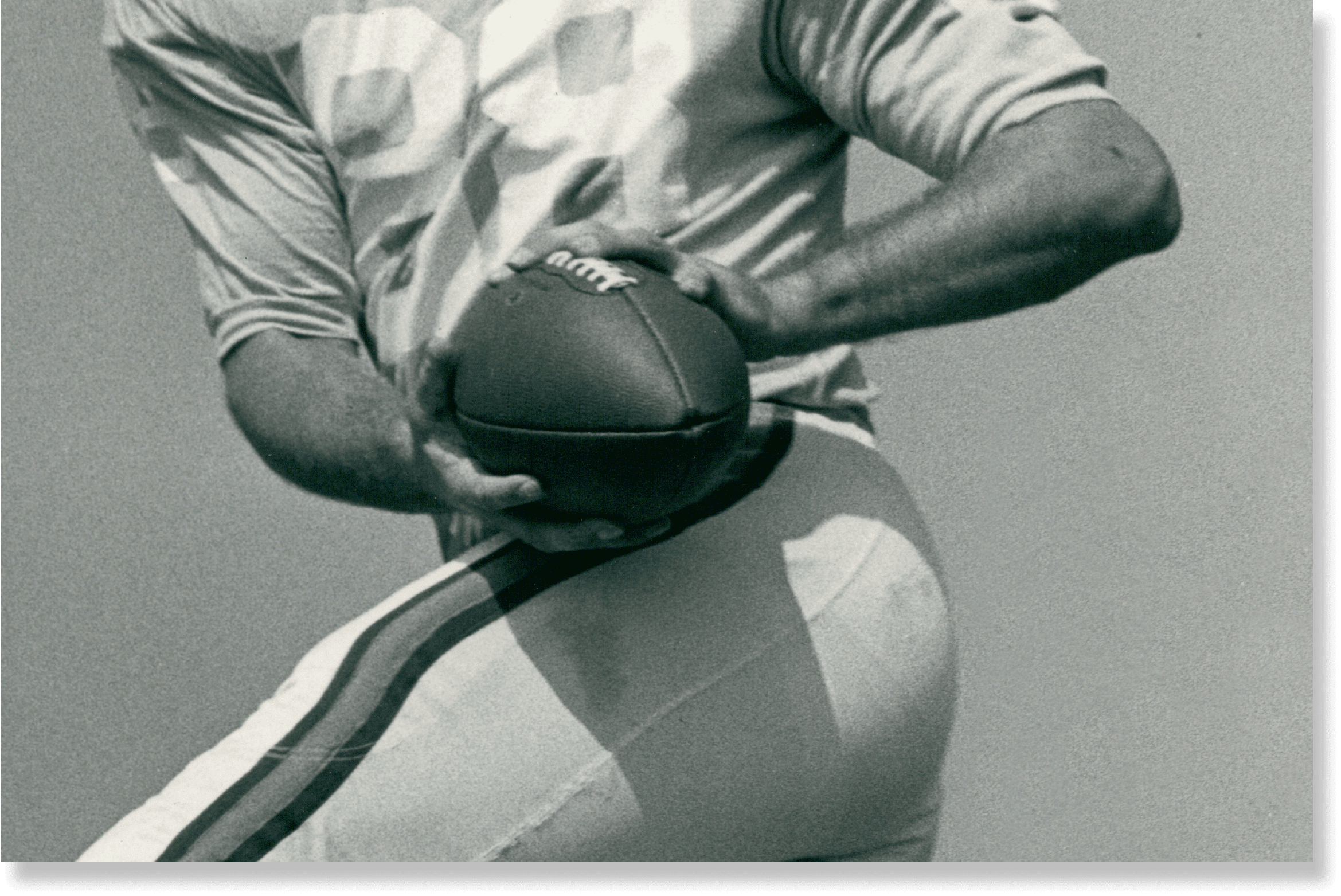 American football player holding the ball.
